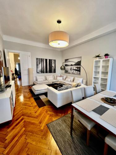 a living room with a white couch and a table at Four reasons apartment in Prague