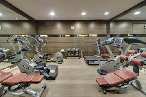 a gym with several treadmills and cardio machines at Meliá Genova in Genoa