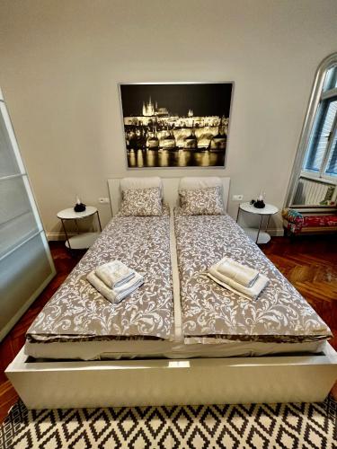 a bedroom with a bed with two towels on it at Four reasons apartment in Prague
