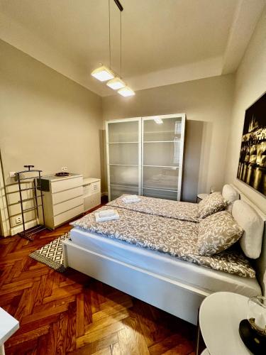 a bedroom with a bed and a dresser at Four reasons apartment in Prague