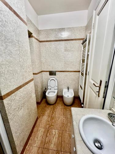 a bathroom with a toilet and a sink at Four reasons apartment in Prague