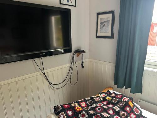 a flat screen tv hanging on a wall at Vintage apartment with fresh sea air and pets in Kristiansund