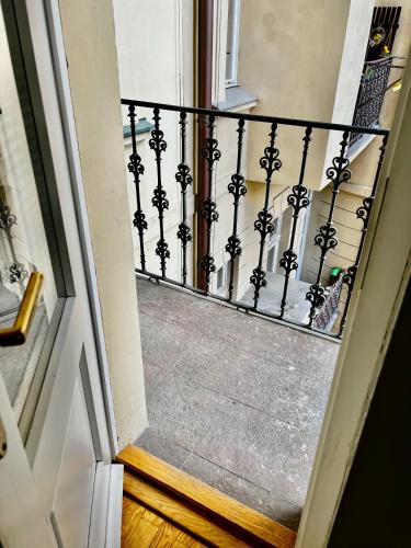 a stairway with a black wrought iron railing at Four reasons apartment in Prague