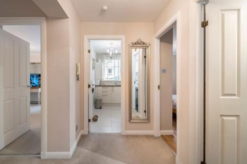 a hallway with a door leading to a kitchen at Immaculate City Centre Apartment with Free Parking - Ground Floor in Aberdeen