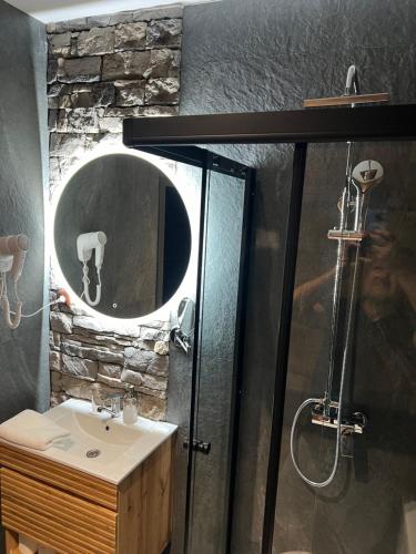 a bathroom with a shower and a sink and a mirror at Vrbecká restaurace- penzion 1 in Hrubá Vrbka