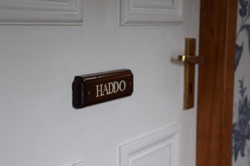 a door with a halo sign on it at Saplinbrae Hotel and Lodges in Mintlaw