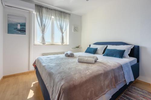 a bedroom with a large bed with two pillows on it at Vema 1 in Selce