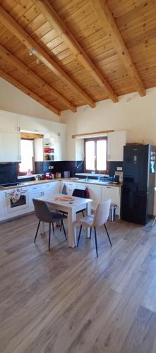 a kitchen with a table and chairs in a room at Summer Villa with sea view,6 min drive from airport, near Seitan Limania beach in Khordhákion