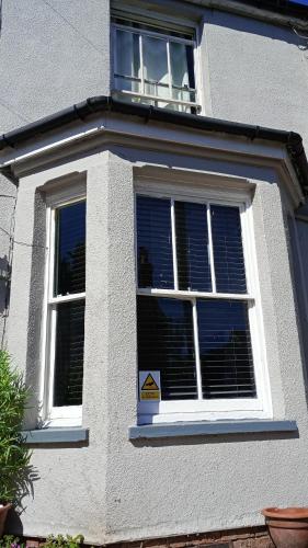 a white house with a window with a sign in it at Number 14 in Ipswich