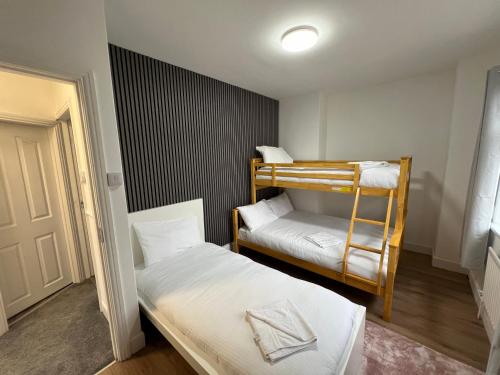 a small room with two bunk beds in it at Numero Venti Aparthouse wifi parking Hot Tub in Newcastle upon Tyne