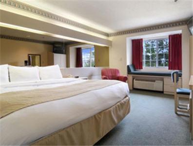a hotel room with a large bed and a window at Stay Express inn and Suites Atlanta Union City in Union City
