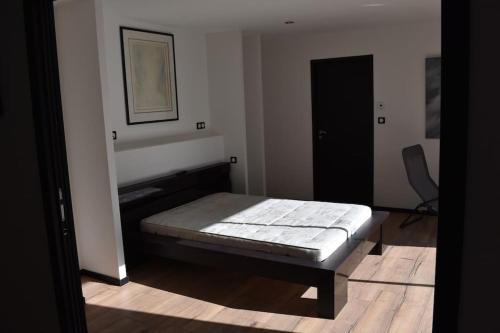 Un dormitorio con una cama en la esquina de una habitación. en superbe villa neuve, en Aytré