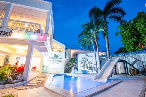 a swimming pool with a slide in front of a house at Pupae Pool Villa Jomtien Pattaya in Jomtien Beach