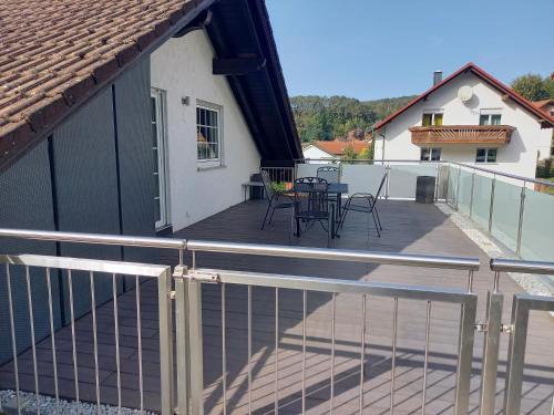 a deck with chairs and a table on a house at Ferienwohnung Haus Peterstal in Trulben