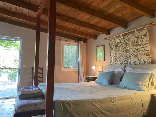 a bedroom with a bed with a wooden ceiling at Gentilini Retreat in Argostoli
