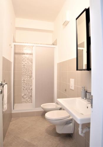 a bathroom with a toilet and a sink and a shower at Republic B&B in Bitonto