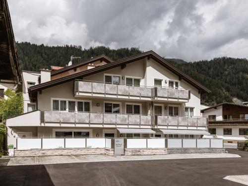 a building with a balcony on top of it at Apartmenthaus Goldeck in Ried im Oberinntal