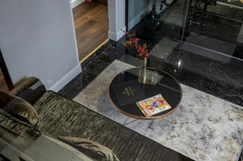 a table with a vase on top of a couch at Mert Boutique Hotel in Korçë