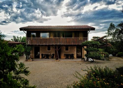 a large house with a deck on top of it at Les Constancies luxury Villa 24-34 pers in Valades