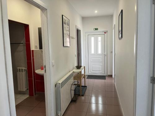 a hallway with a white door and a sink at Casa de Casarelhos - "Gerês" - Estúdio piso 0 - Apartamento Piso 1 in Geres