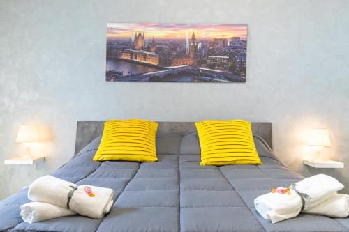 a bedroom with a bed with yellow pillows at URBAN House in Rivoli