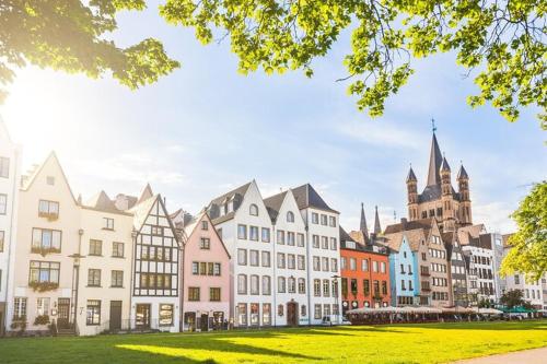 a group of buildings with a church in the background at Haus Enteresan in Cologne