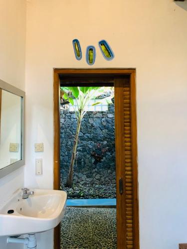 a bathroom with a sink and a window at Yoga Lover in Yogyakarta