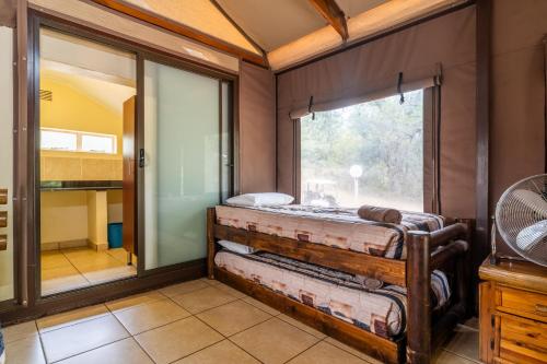 a room with a bed and a window in it at ATKV Buffelspoort in Rustenburg