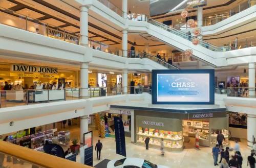 a shopping mall with a large screen in the middle at SPR House Chatswood 3 bedrooms - 1 in Sydney