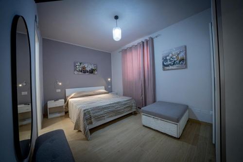 une chambre avec un lit et un banc dans l'établissement Residenza NETTUNO, à Tropea