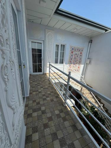 a balcony of a house with a railing and a door at Boutique Boulevard Bukhara in Bukhara