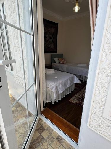 a room with a room with a bed and a window at Boutique Boulevard Bukhara in Bukhara