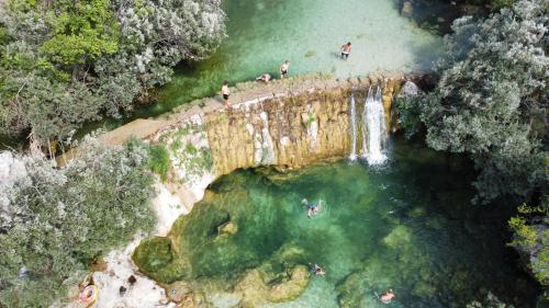 an aerial view of a waterfall and a body of water at Relax Apartments Trebinje in Trebinje