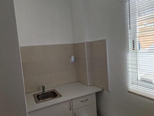 a small kitchen with a sink and a window at Casa Cabo de Gata in Retamar