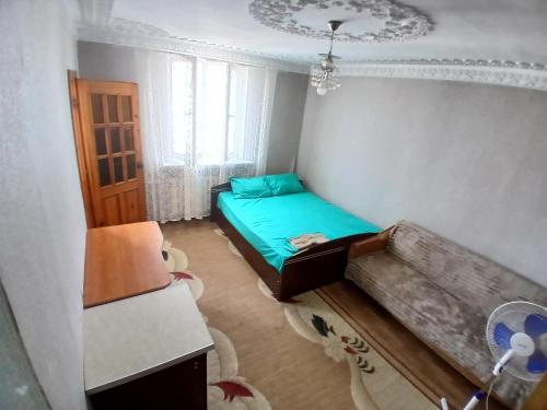 a small bedroom with a bed and a couch at apartment for rent STD in Chişinău