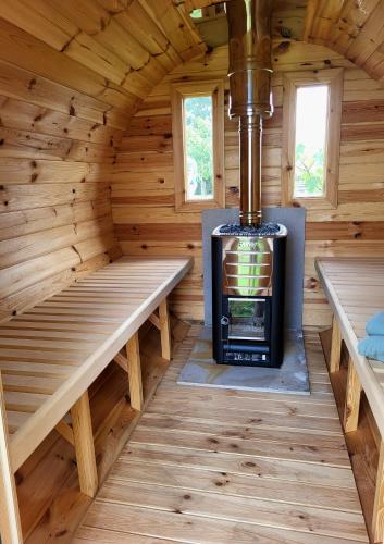 a log cabin with a wood stove in it at Jelsum aan de Ee in Jelsum