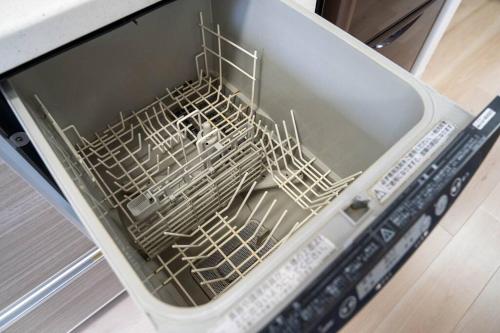 a dishwasher with a drying rack inside of it at Flex cella satozuka in Ōmagari