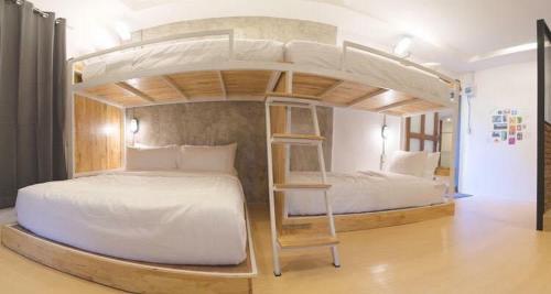 a bedroom with two beds and a bunk bed at Sabainimman Chiangmai in Ban Choeng Doi Suthep