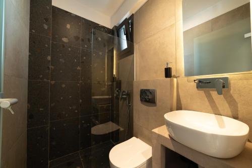 a bathroom with a toilet and a sink and a shower at Horeizons Modern Living in Nea Vrasna