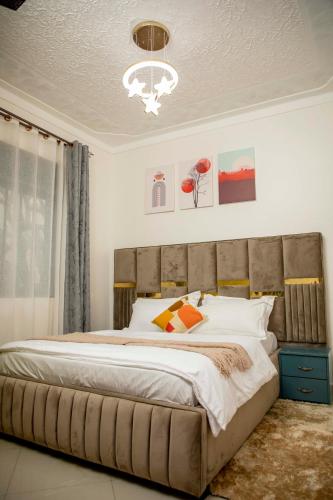 a bedroom with a large bed in a room at Lovana Apartments and Hotel, Gulu City in Gulu