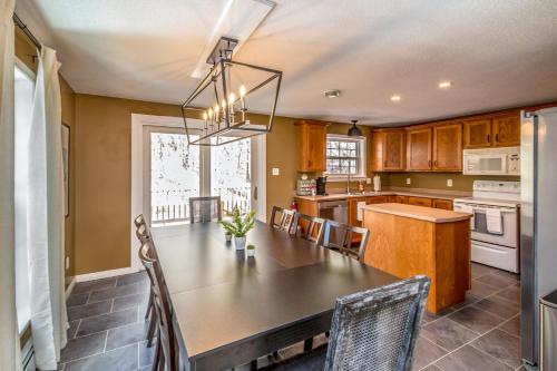 a kitchen with a wooden table and a dining room at Your Perfect Blend of Views, Hot Tub, and Fun! home in Conway