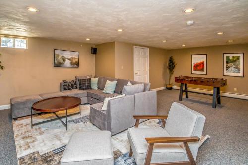 a living room with a couch and a table at Your Perfect Blend of Views, Hot Tub, and Fun! home in Conway