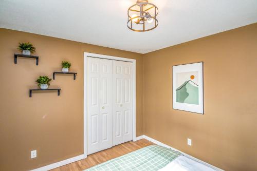 a bedroom with a white door and a chandelier at Your Perfect Blend of Views, Hot Tub, and Fun! home in Conway