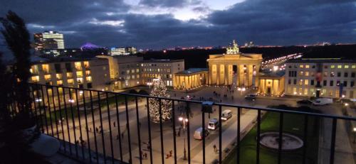 a view of a city at night with a christmas tree at NexLiving Berlin Brandenburger Tor in Berlin
