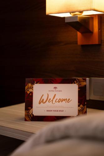 a welcome sign on top of a table at Hotel Tamara Melaka in Melaka