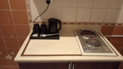 a kitchen counter with a stove and a coffee pot at Etlalat Obhur in Jeddah