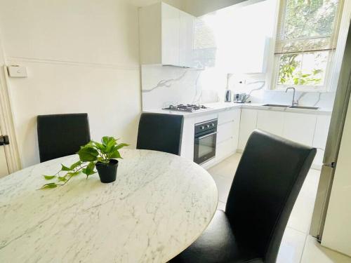 a kitchen with a table with a potted plant on it at SPR house Chatswood - 3 bedrooms -2 in Sydney