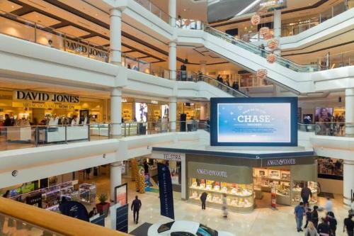 a shopping mall with a large screen in the middle at SPR house Chatswood - 3 bedrooms -2 in Sydney