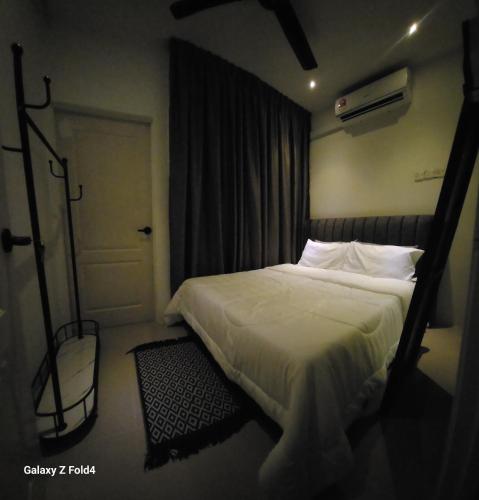 a bedroom with a bed and a door with a window at Homestay Kubang Kerian by The Stay Homestay 03 in Kota Bharu