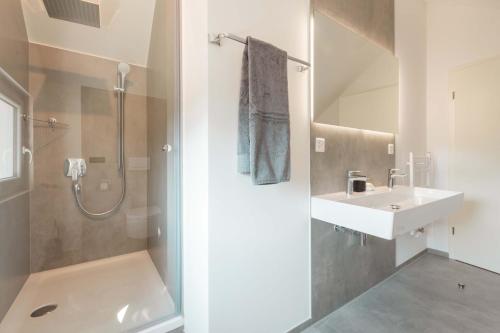 a bathroom with a shower and a sink at LEVA Stay Luzern-Interlaken I Nature I Familie in Sarnen